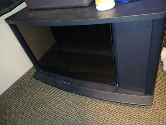 TV. Stand. With a side compartment.and a glass compartment with shelves in front.
