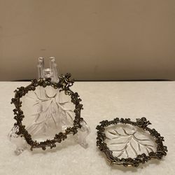 2 beautiful vintage vanity dishes. Intricate design. Leaf shape. Cupid siting on top. Collection pieces. Really nice for your jewelry, etc. in good co
