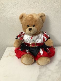 Build A Bear Workshop Teddy Bear Wearing A Really Cute Pirate Dress.  The Dress Is New.  Size 15 Inches Tall.  Preowned excellent condition.  Has been