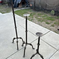 Three heavy iron candle holders