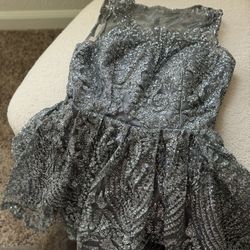 Make a grand entrance in this stunning silver-grey gown covered in intricate glitter and sequin embroidery. Comes with a matching embellished tulle ve