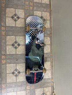 Naruto Kakashi complete skateboard for sale. Used but still rides good. Graphic has normal scratches from use, trucks and wheels are solid, and grip t