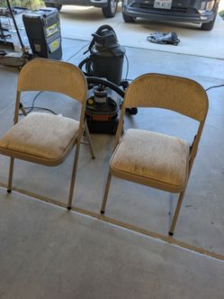 Two brown folding chairs