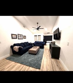 Sofa, loveseat and rug. Couches are blue