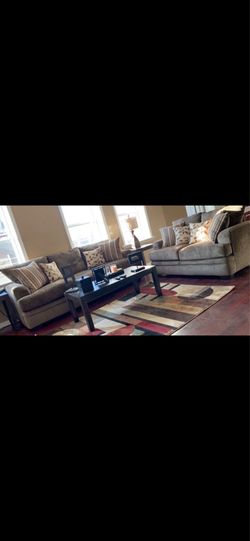 Brown love seat and sofa