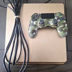 PlayStation golden ps4 slim with 1 terabyte with a controller the chords the cords