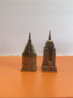 Salt and pepper shakers Made of Metal One is the Empire State building and the other one is the Chrysler building