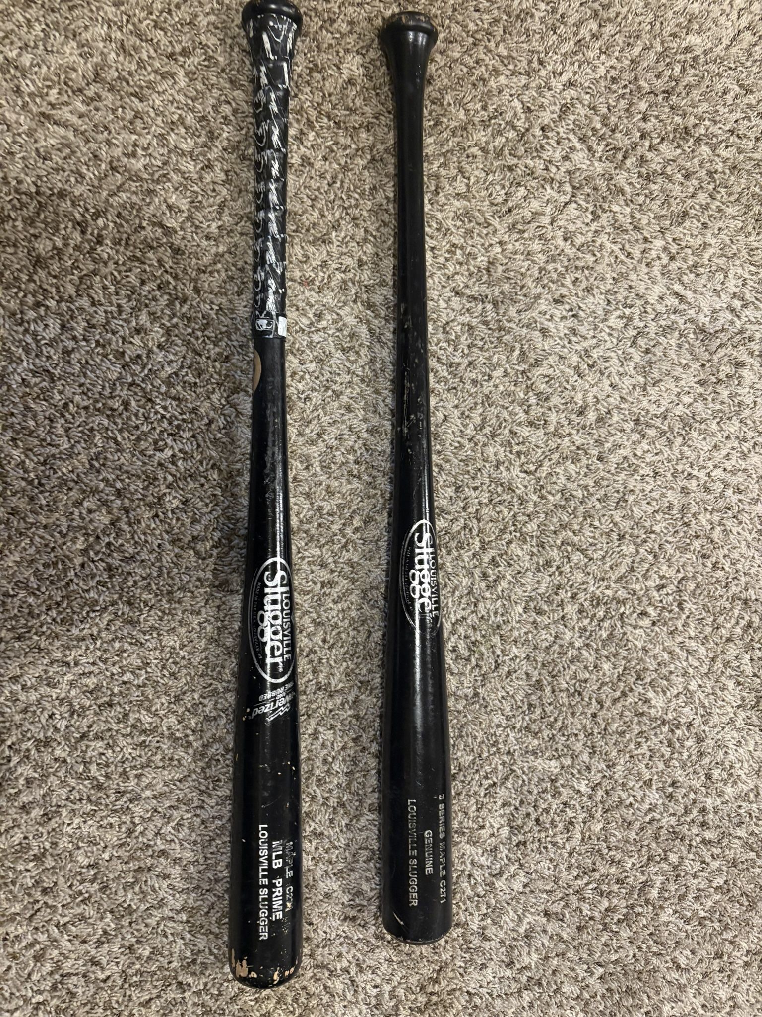 Two Louisville Slugger Genuine Baseball Bats
