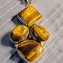 SUCH A BEAUTY! BIG, BOLD, & BEAUTIFUL.  GENUINE TIGER'S EYE, YOU GET* FOUR* LARGE CABOCHONS ALL SET IN STERLING, ON 18 INCH, STERLING CHAIN.. 