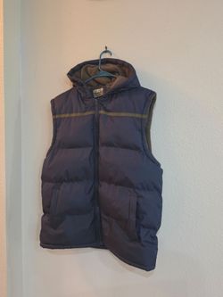 Store 68 Hooded Puffer Vest in navy blue, featuring an integrated hood with a cozy fleece lining, a full-front zip closure, horizontal down quilting, 