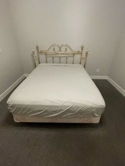 Queen size bed with gold metal headboard