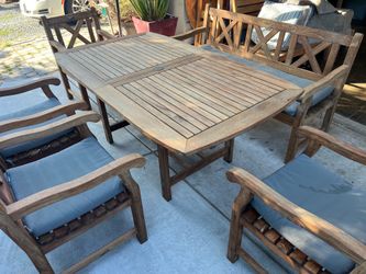 Regency Teak Brand Outdoor Patio Teak rectangular table with matching bench and 4 chairs and sunbrella gray cushions   Located in concord  Recently cl