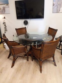 Round glass table with four chairs