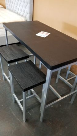 Black and silver counter height table with 4 stools