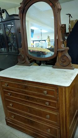 Walnut dresser on wheels with marble top