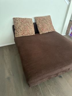 Brown Fabric Sofa Bed with Paisley Pillows