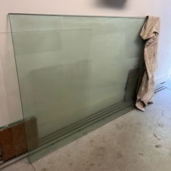 1/2” thick glass 65”x43 chipped