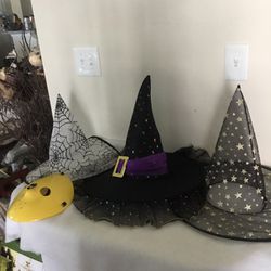 Three Halloween witches hats and one plastic scary mask Thumbnail