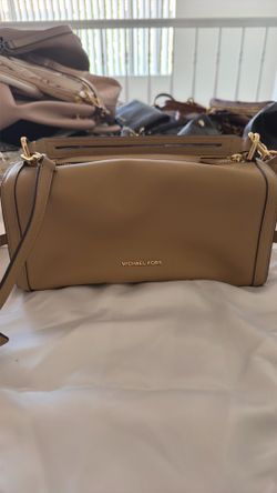This beige Michael Kors crossbody bag features gold-tone hardware and a structured, rectangular design