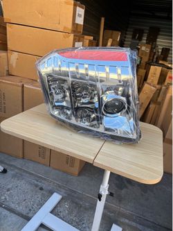 replacement headlight assembly for a 2007-2014 Cadillac Escalade, featuring a chrome housing and projector lens right side