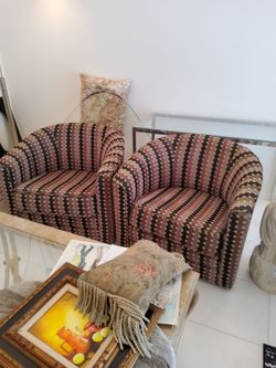 Two swivel barrel chairs