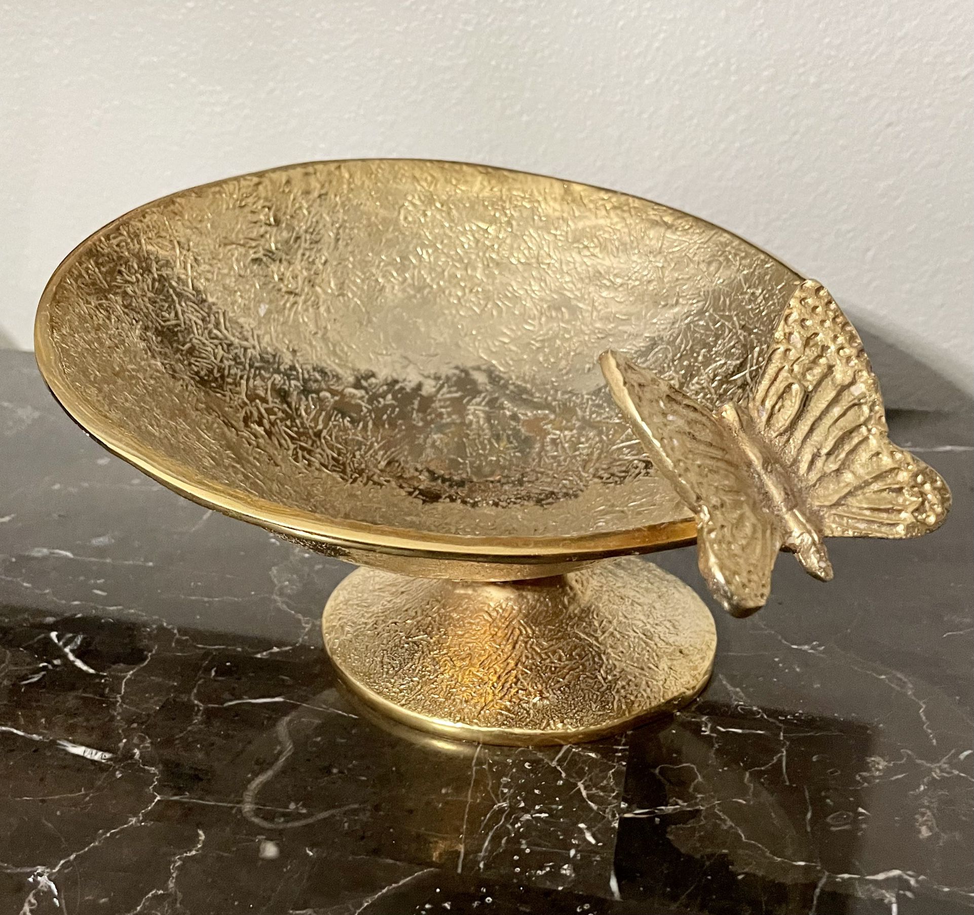 Beautiful asymmetrical metal pedestal bowl with butterfly.