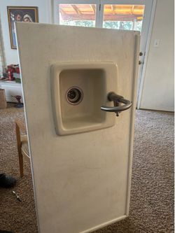 Small Sink  and a faucet and on wood top