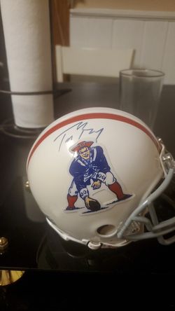 1961 Boston patriots signed team football....tom brady signed mini helmet.....items come with letter of authenticity from Gerhard schwedes...