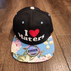 Headline brand black snapback cap featuring embroidered "I ❤️ Haters" text and a floral print brim.