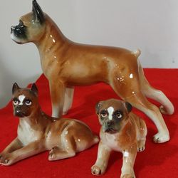 Vintage High Gloss Porcelain, 3 Sitting Boxer Dog Figurines, two of them repaired by the previous owner, sold as is.