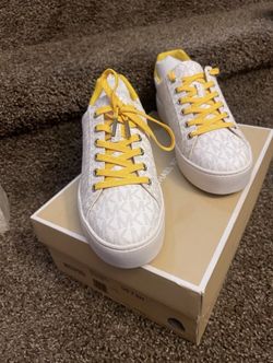 7.5 women’s yellow and white Micheal Kors sneakers