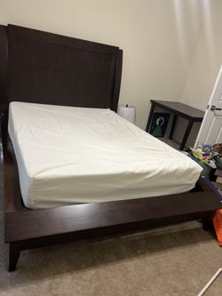 QUEEN SIZED DARK WOOD SLEIGH BED