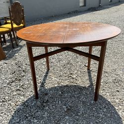 MCM Extending Oval Dining Table in Teak . Needs refinishing  42” wide  42” deep  29” tall  Leaf  42” long 18” deep   
