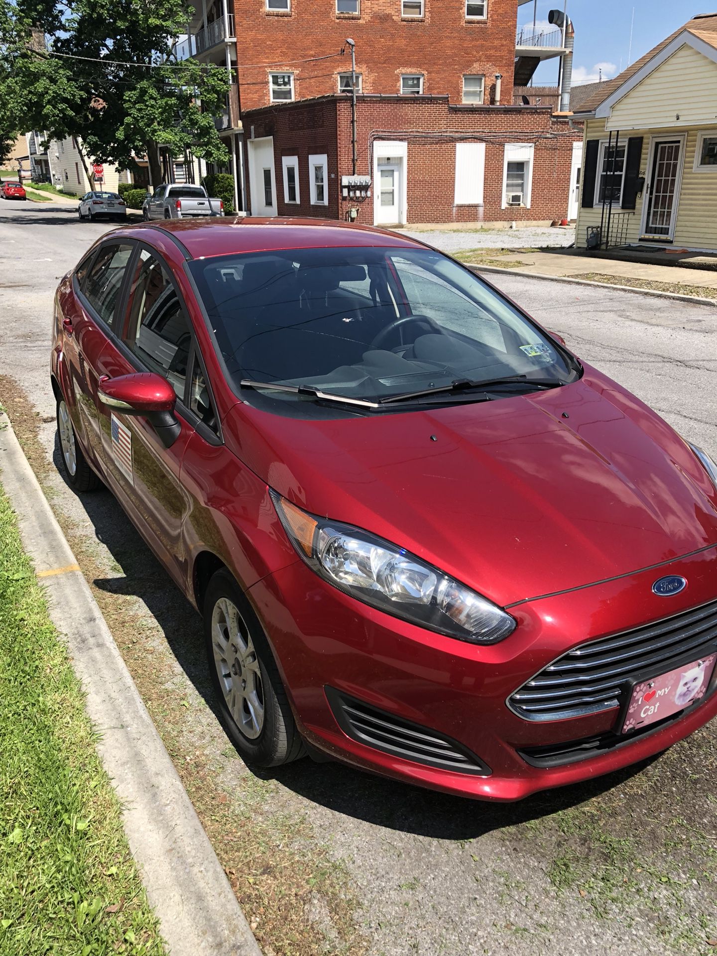 Photo It is 2016 Ford Fiesta it is a 4 door red it as about 13765 miles on it it runs will good it is in very good condition it is a very nice car for a fa
