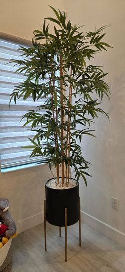 Bamboo faux plant tree with black and gold base white rocks