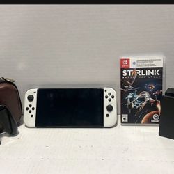 Nintendo Switch OLED With Case, Joycon Grip, Docking Station, And Starling Battle For Atlas Game