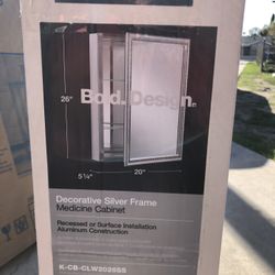 20" W x 26" H aluminum single-door medicine cabinet with decorative silver framed mirrored door