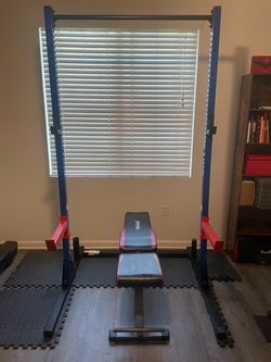 Squat rack with bench and safety bars.