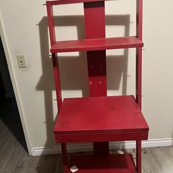 Red shelf with drawer.