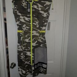 This piece is a sleeveless camouflage hooded zip-up Midi dress with striking neon yellow details.