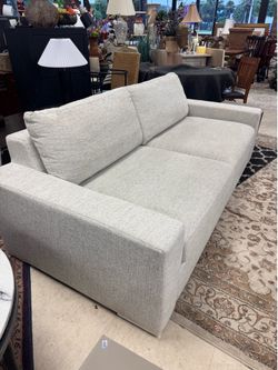 Restoration Hardware  Style Modena Track Arm Sofa features a low-profile design with wide, blocky arms upholstered in a light gray textured fabric