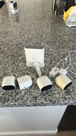 Arlo pro three security cameras with station