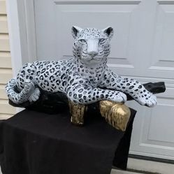 Snow Leopard On The Log 