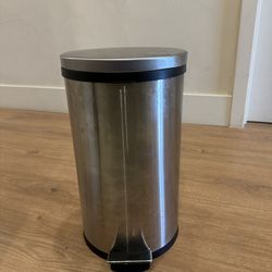Large stainless steal trash can step on lid