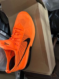 These are Nike Air Max Flyknit Racer sneakers in a Total Orange and Black colorway