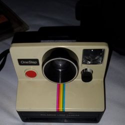  Polaroid One Step Land Camera With Rainbow Stripe With Strap Vintage. Works perfect and comes with I package of film. 

