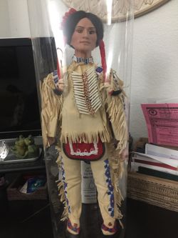 Native American doll in protective plastic case