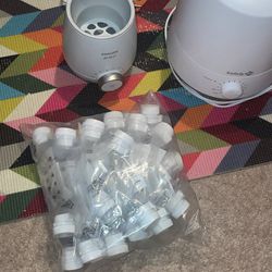 A Baby Bottle, Warmer,A Baby Humidifier And Breast Milk Storage Bags
