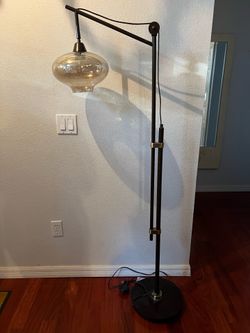 Franklin Iron Works Calyx Industrial Downbridge Task Floor Lamp with an oil-rubbed bronze finish and a cognac-tinted glass shade