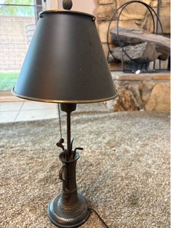 Vintage whimsical table lamp features a base shaped like a golf bag filled with clubs and is topped